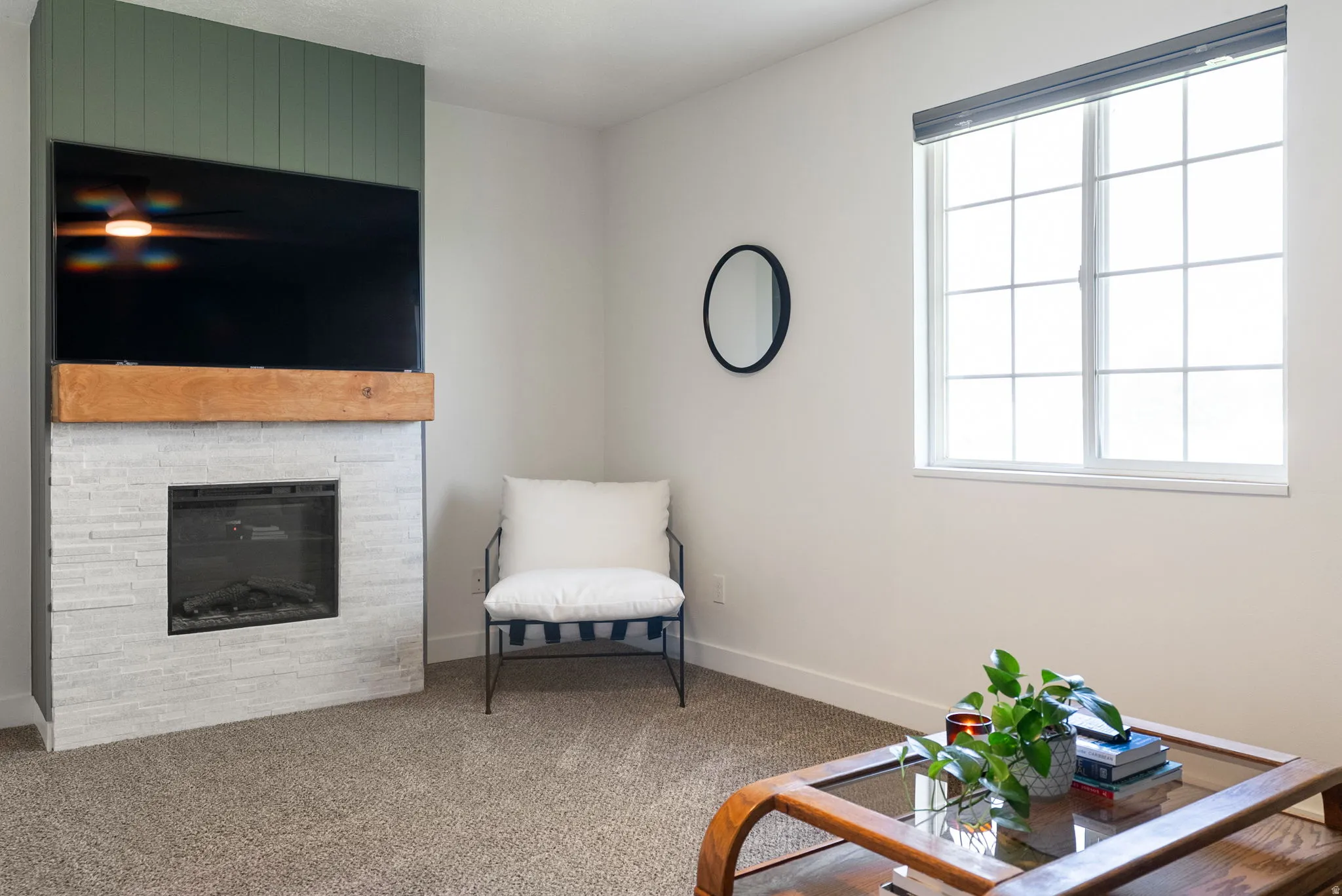 Built-in fireplace with a stone-look surround, wood mantel, and integrated entertainment space