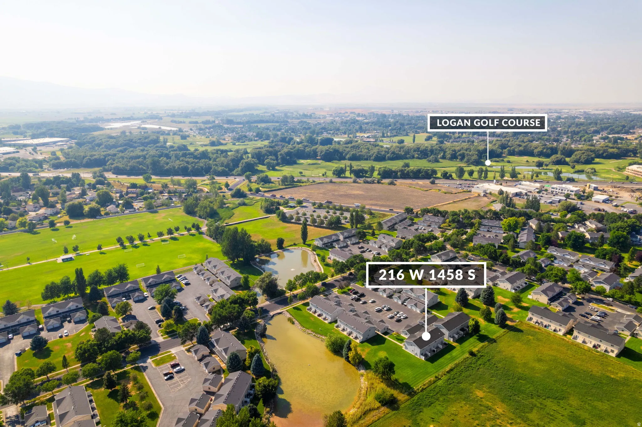 Aerial perspective showcasing surrounding landscape, including green spaces and a golf course