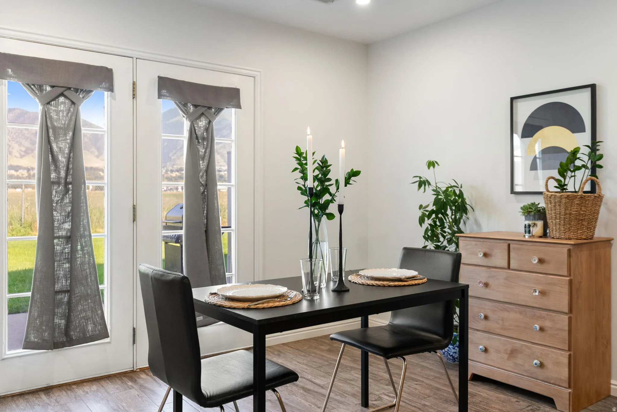 White interior walls, recessed lighting, wood-finish flooring, and white French doors