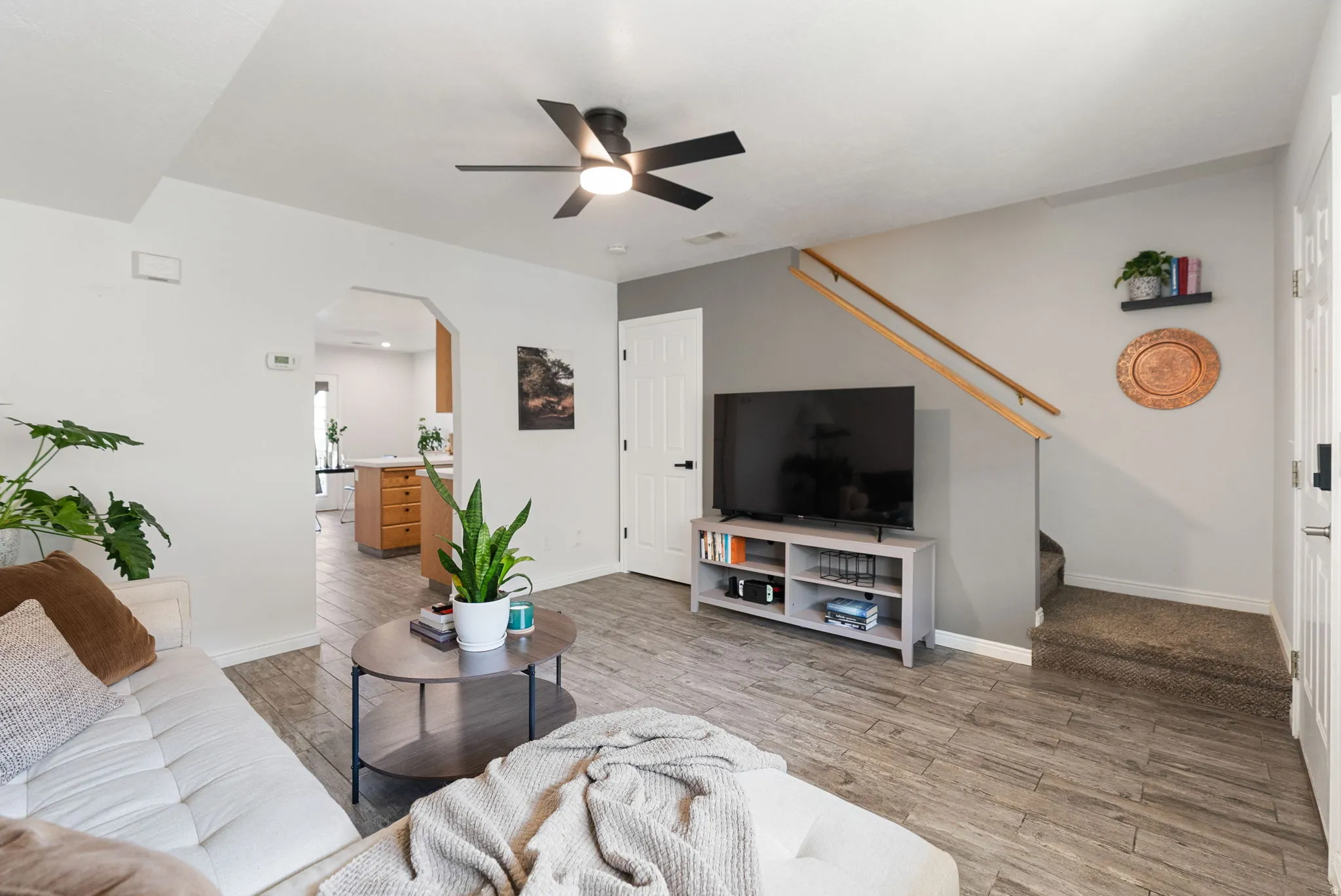 Wood-finish tile flooring, recessed lighting, and a contemporary ceiling fan