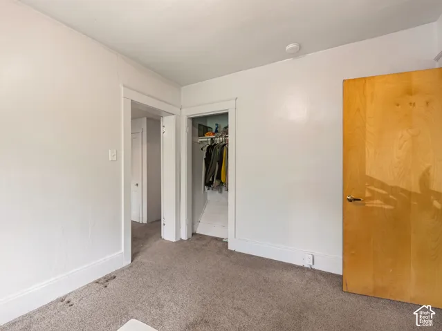 Carpeted room with closet space