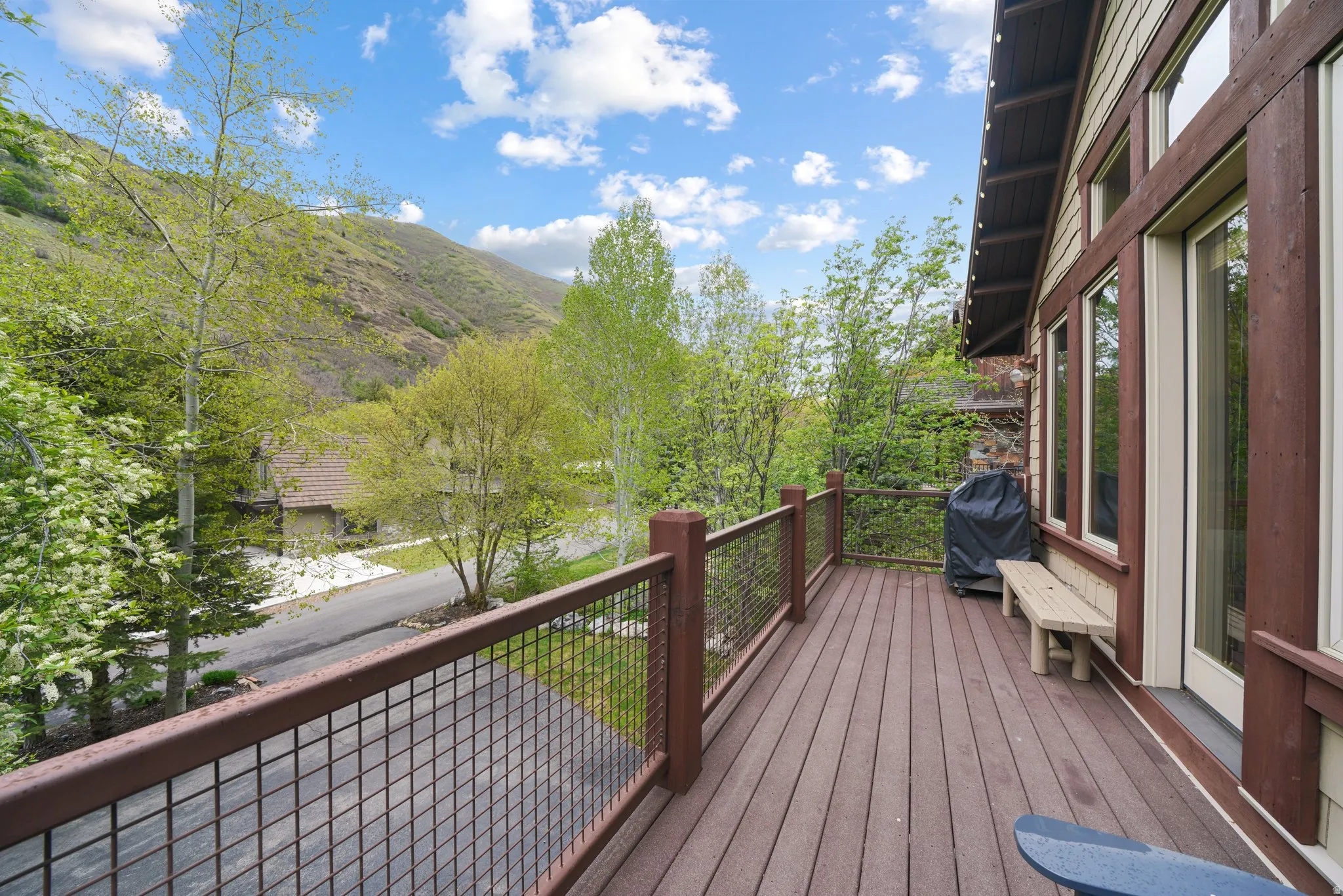 Expansive deck with composite decking, metal grid railing, and direct access to the interior