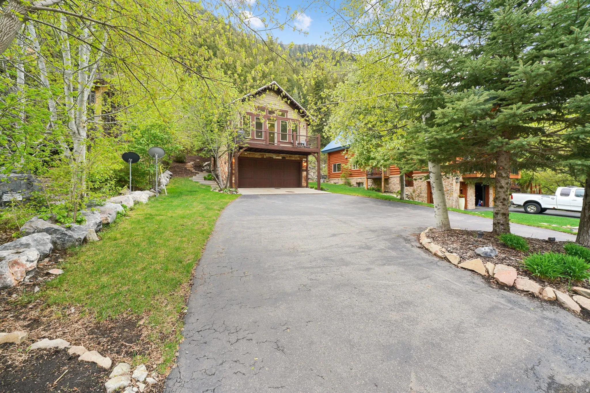 Paved driveway leading to a two-story residence with an integrated garage