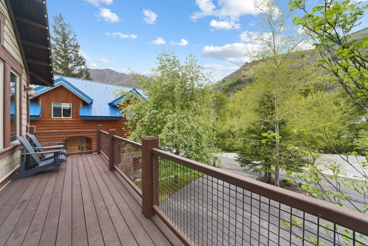 Expansive outdoor deck with composite decking, cable railing, and mountain scenery