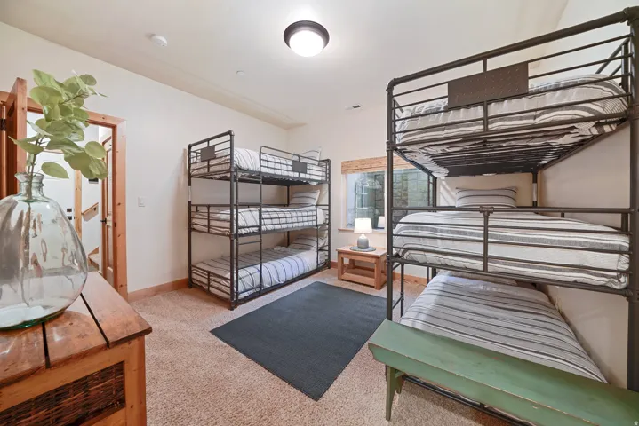 Carpeted flooring, recessed lighting, and a window with a wood-finish blind