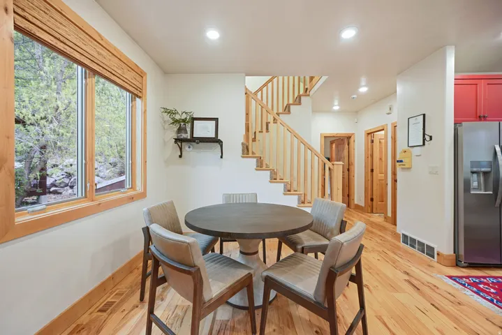 Wood-finish flooring, recessed lighting, and a wood-framed window