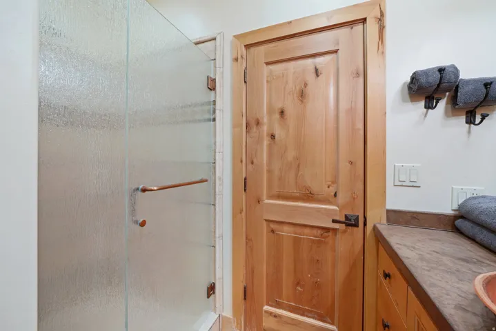 Frosted glass shower enclosure with bronze-finish hardware