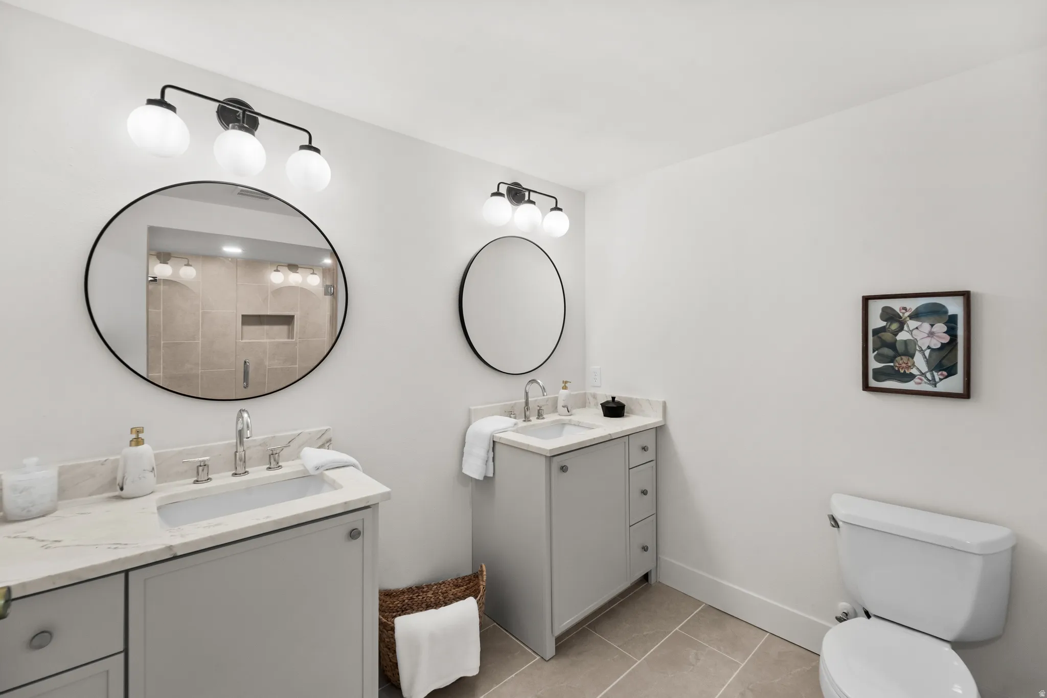 Dual vanity with light gray cabinetry, light-toned countertop, and undermount sinks