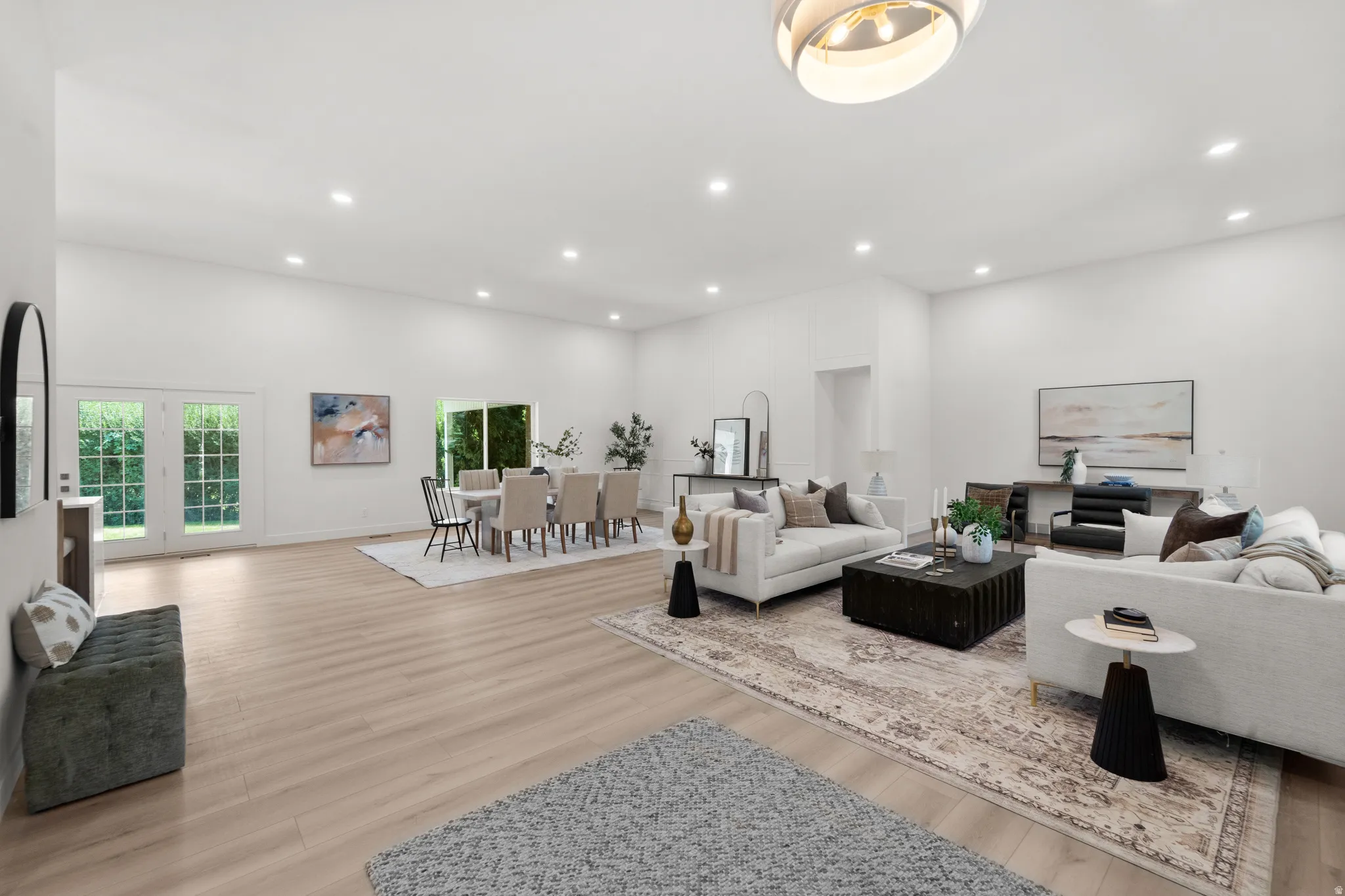 Vaulted ceilings, recessed lighting, wood-finish flooring, and white walls