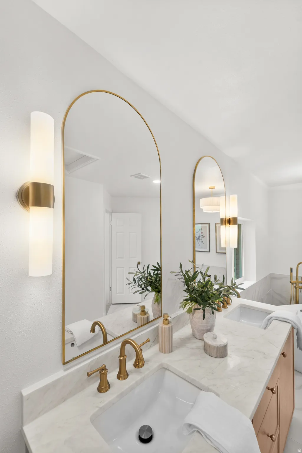 Dual arched mirrors with gold-finish frames
