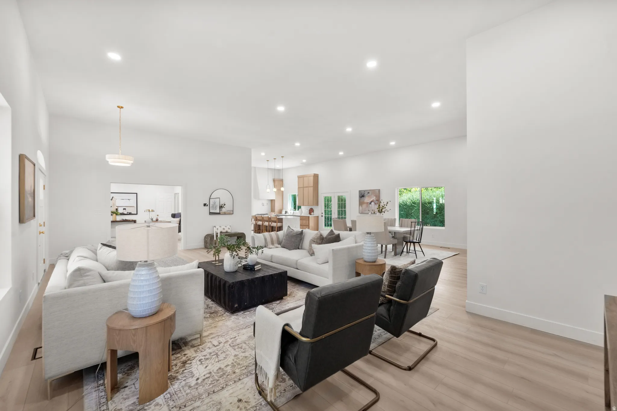 Vaulted ceilings and recessed lighting illuminate the open-concept living space with wood-finish flooring