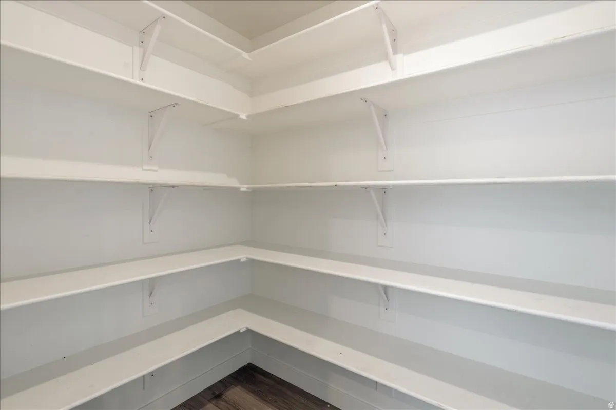 Wraparound shelving with a white finish and wood-finish flooring