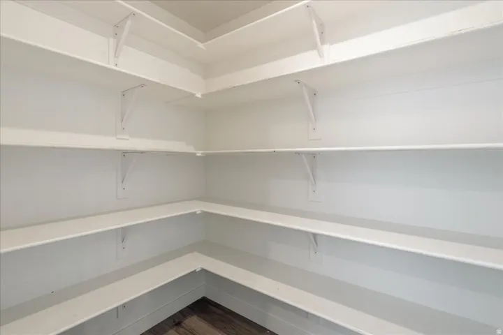 Wraparound shelving with a white finish and wood-finish flooring
