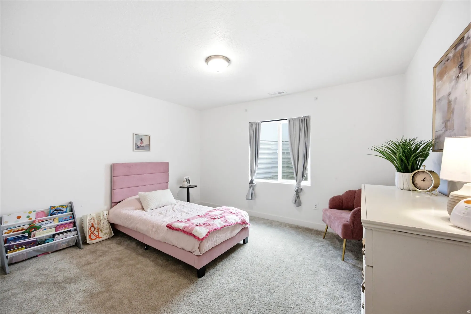 Recessed window with gray drapes, plush carpet flooring, and white walls