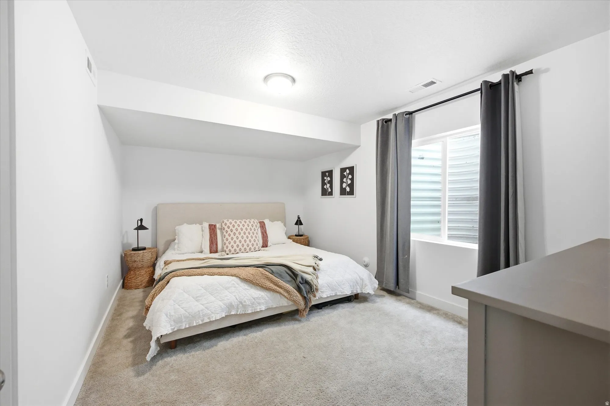 White walls with a textured ceiling and recessed lighting