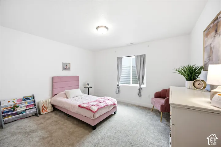 Recessed window with gray drapes, plush carpet flooring, and white walls