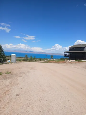 Expansive open lot with distant water and mountain scenery