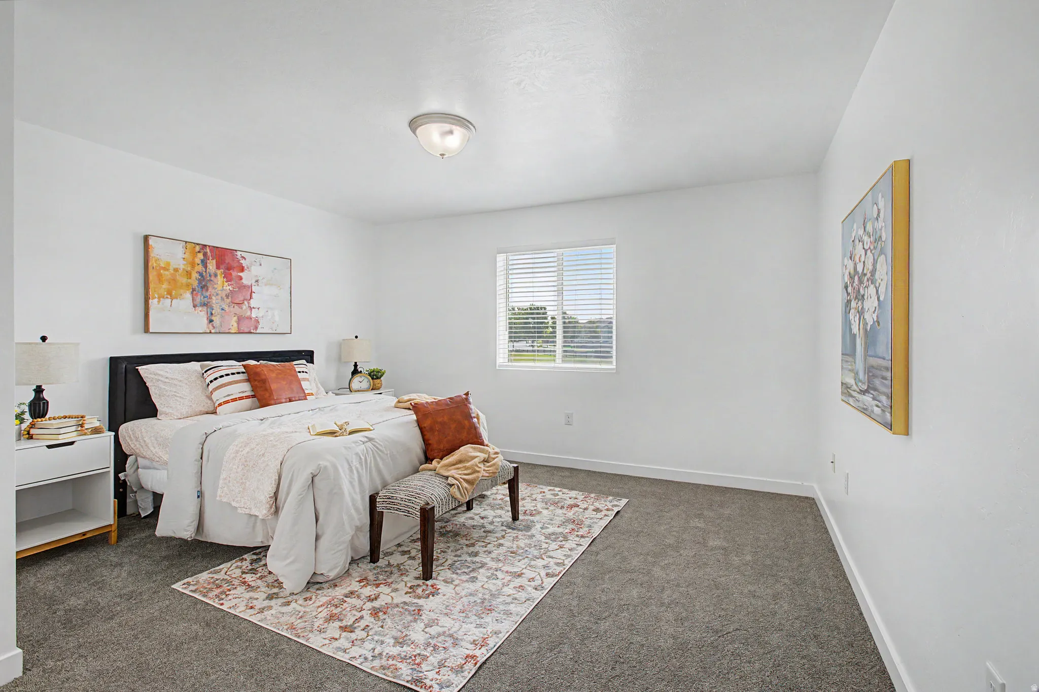 White walls, gray carpet, and a window with blinds