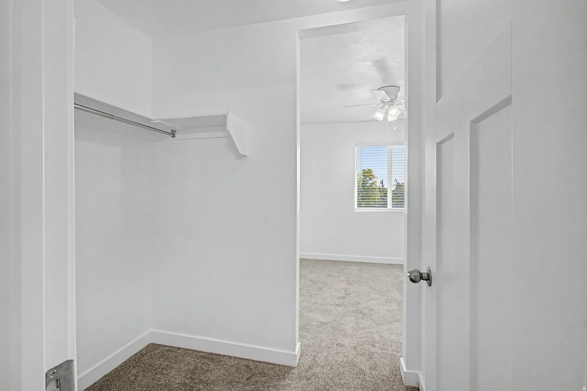 Closet featuring built-in shelving and hanging rod