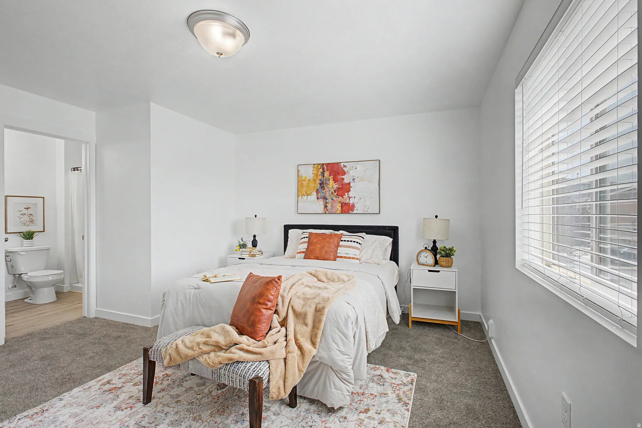 Carpeted flooring, white walls, flush mount ceiling light, and a window with blinds