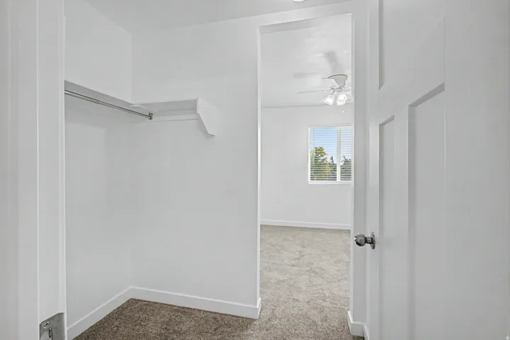 Closet featuring built-in shelving and hanging rod