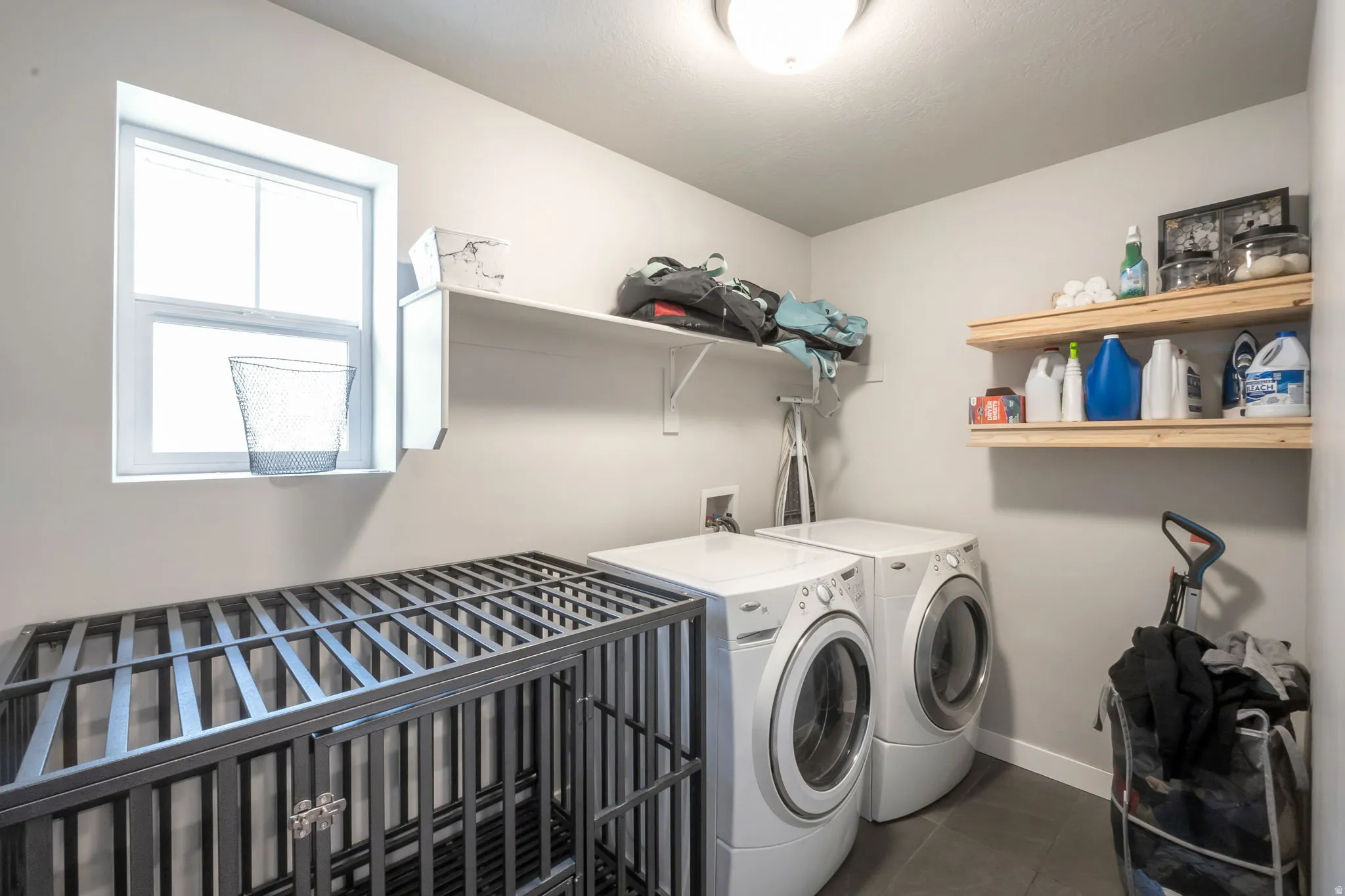 Dedicated laundry area featuring washer and dryer included