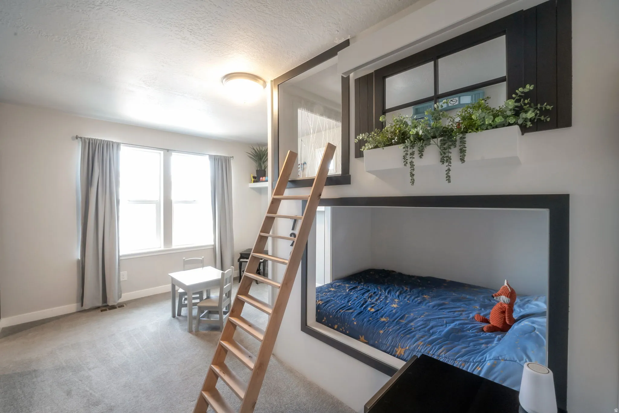 Built-in bunk bed with ladder access and a window box planter
