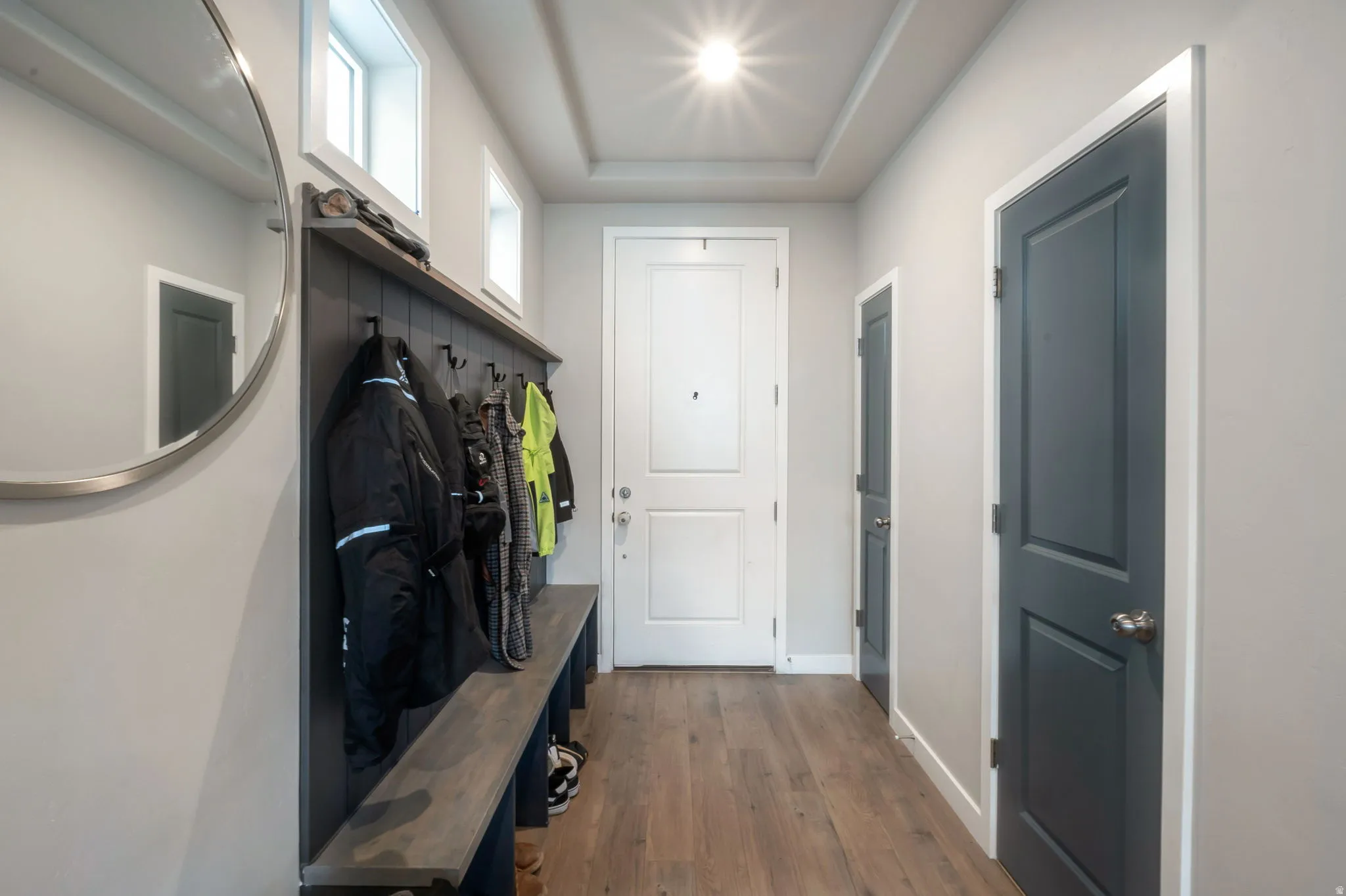Entryway featuring bench and coat hangers