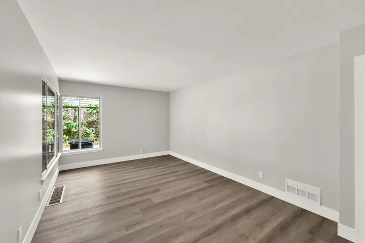 Wood-finish flooring with light gray walls and white trim