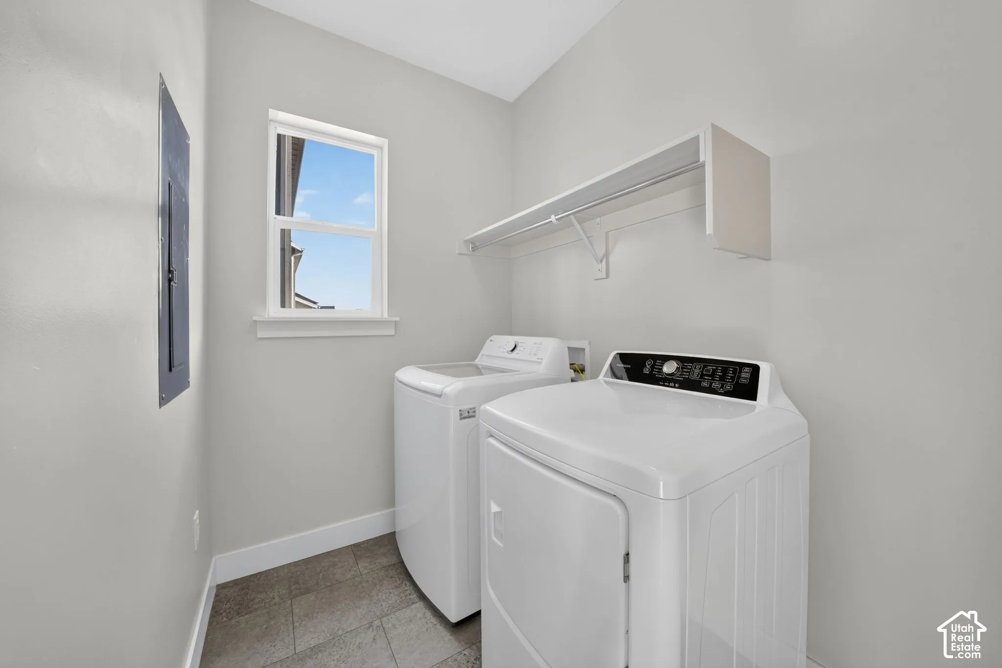 Utility space featuring tiled flooring and a window with natural light