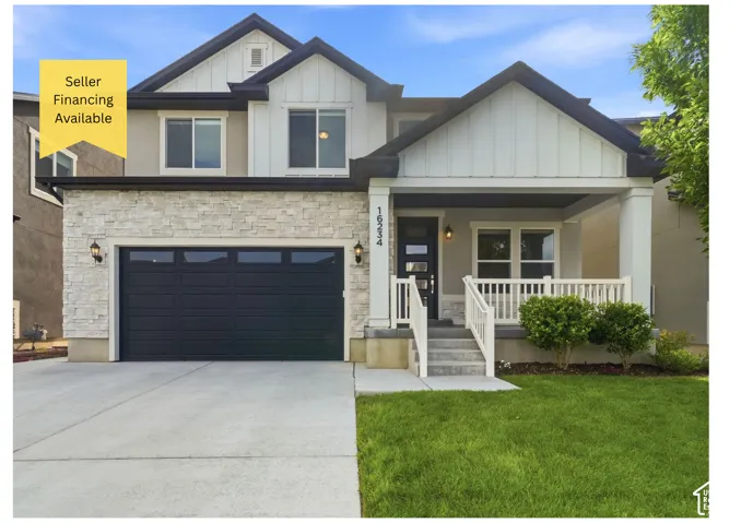 Contemporary exterior with stone veneer and board and batten accents