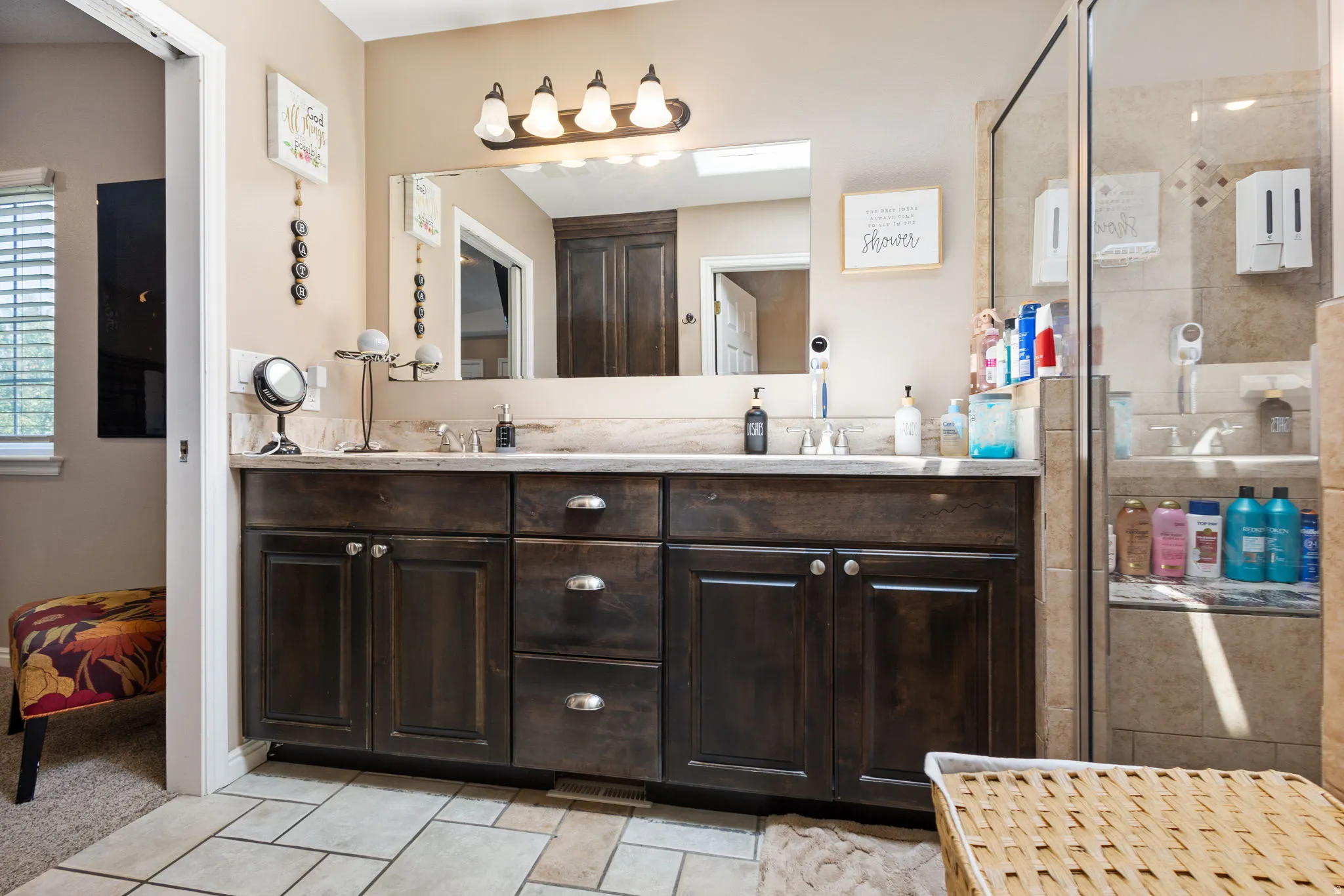 Dual vanity with dark wood-finish cabinetry, light-toned countertop, and undermount sinks