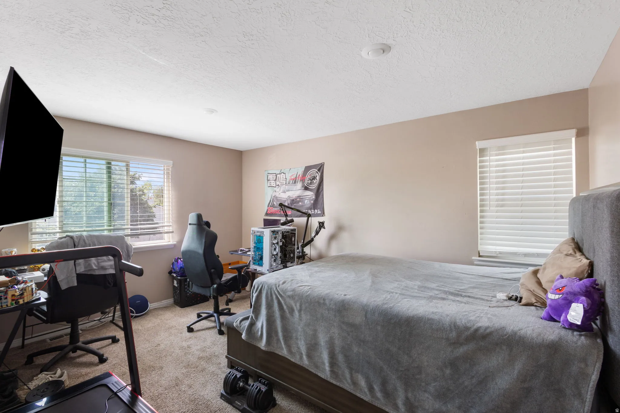 Window treatments with horizontal blinds, neutral wall paint, and recessed lighting fixtures