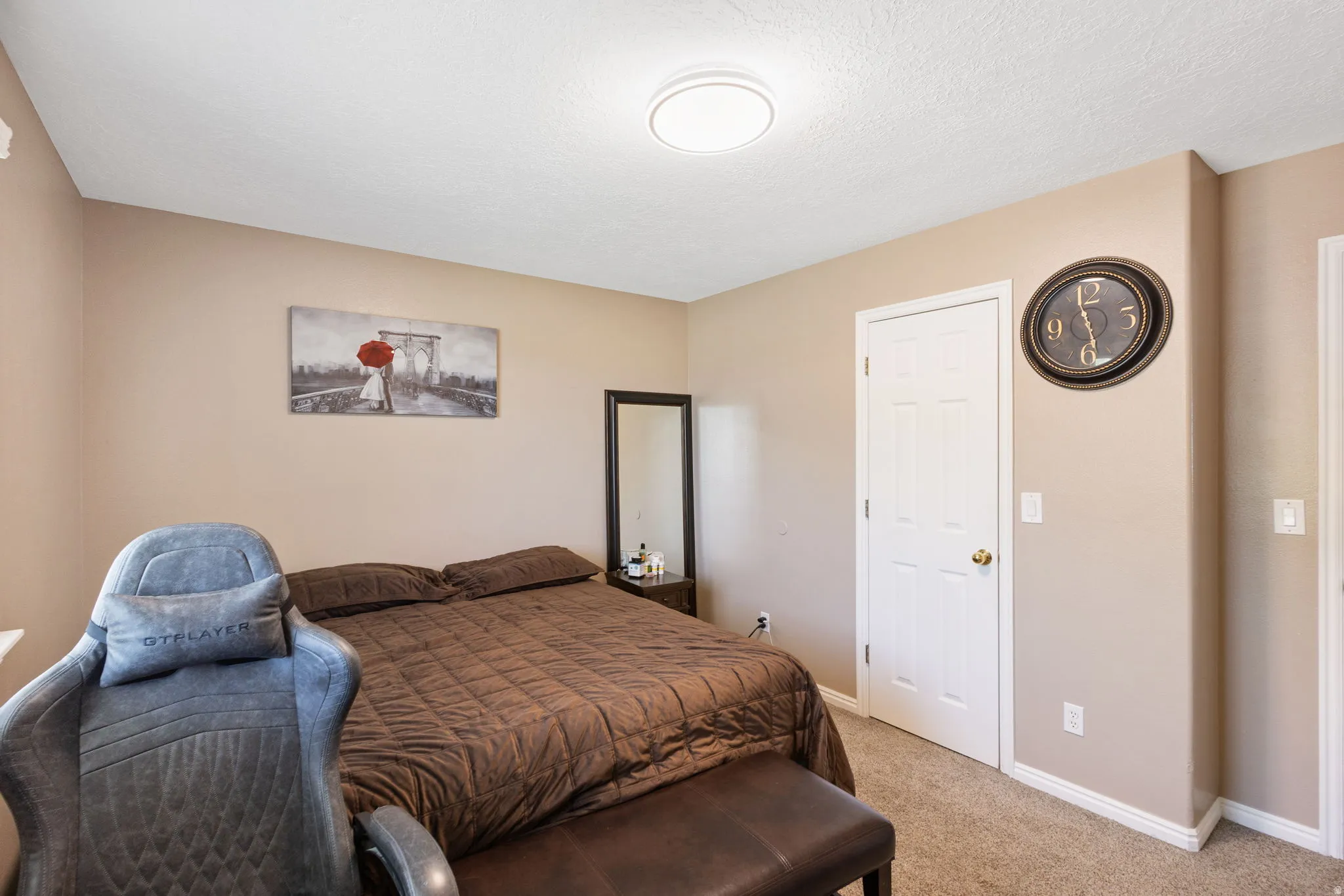 Neutral wall color with white trim, built-in door, and ceiling-mounted light fixture