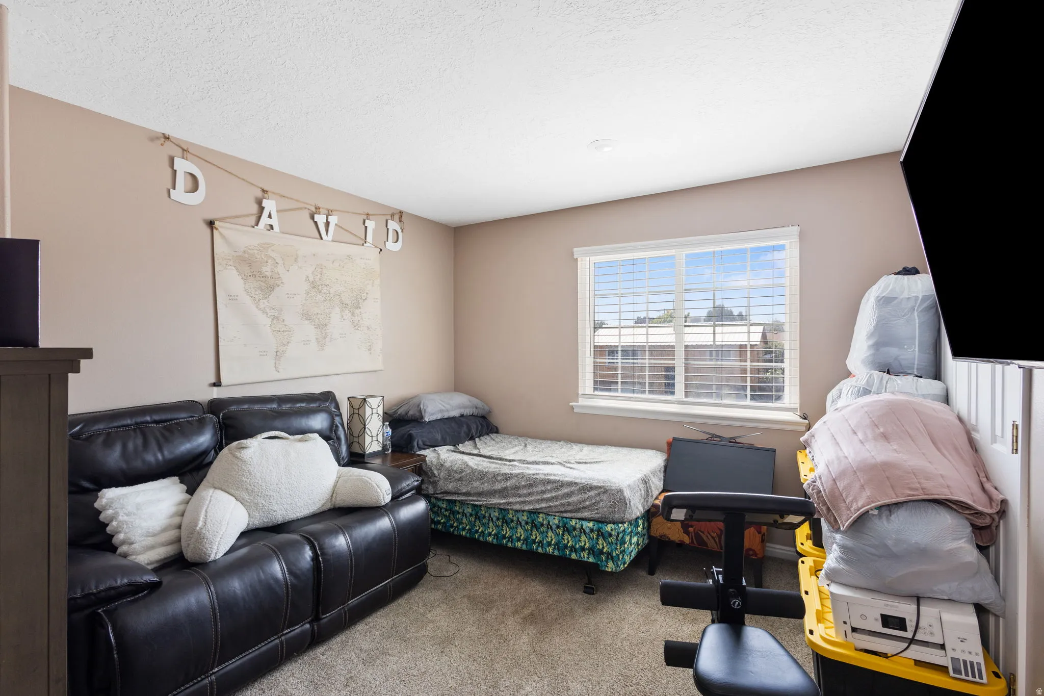 Recessed lighting, neutral wall paint, white trim, carpet flooring, and a large window with blinds
