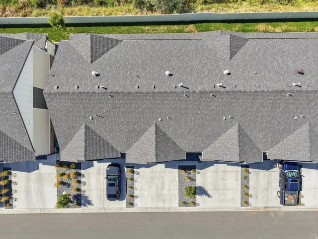 Asphalt shingle roofing, concrete driveways, and landscaped rock beds