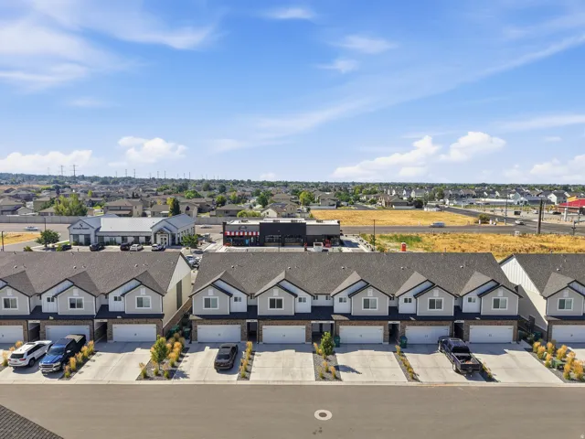 Attached multi-unit residences featuring individual garages and paved driveways