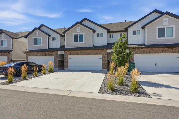 Modern townhome exterior featuring brick and siding finishes