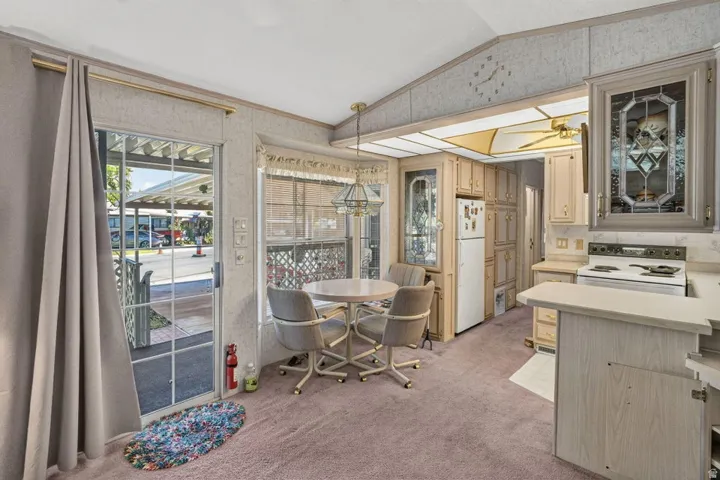 Kitchen featuring wood-finish cabinetry, built-in appliances, and a breakfast bar