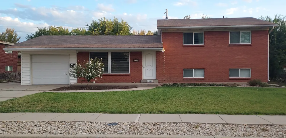 Red brick exterior with white trim windows