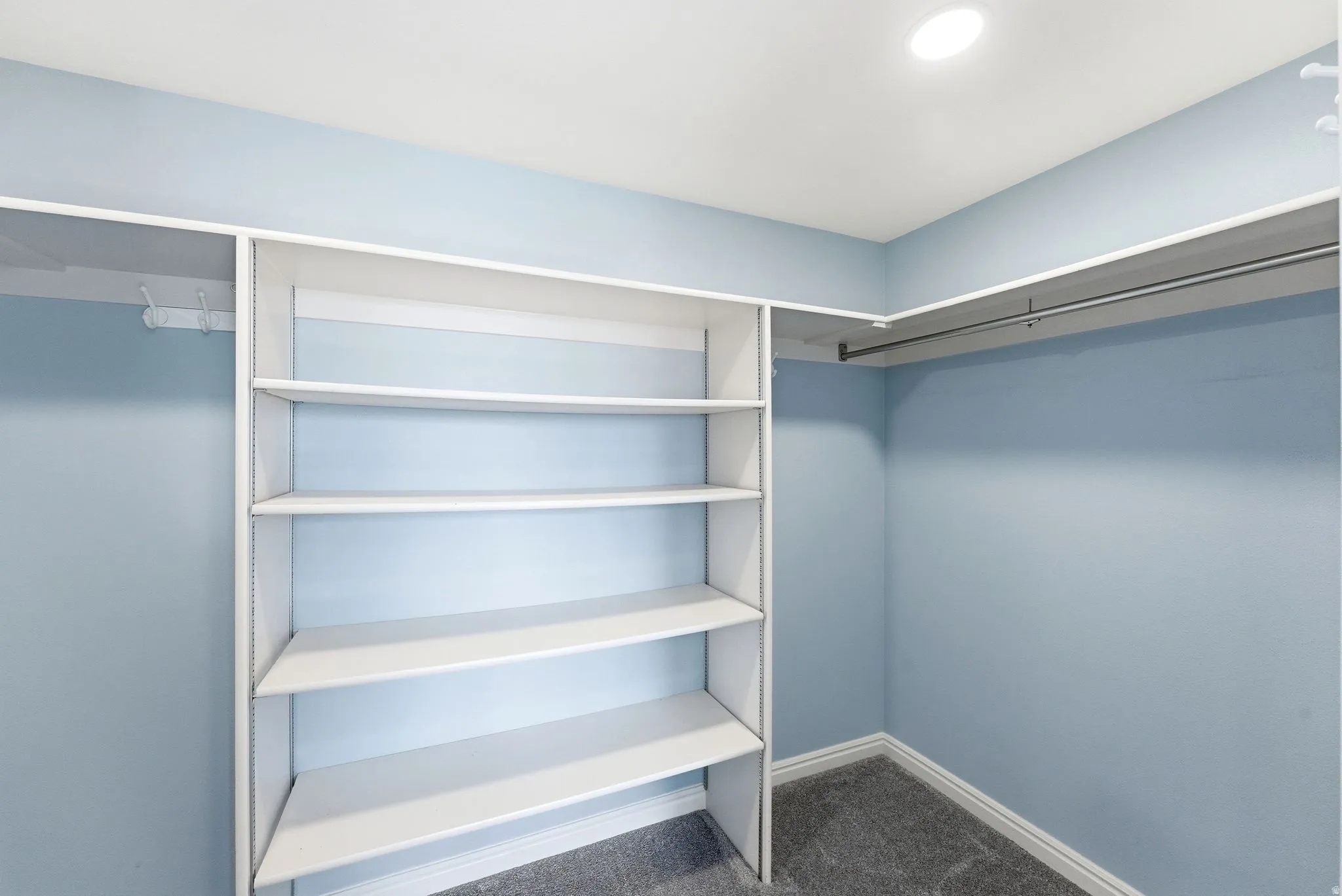 Built-in closet system featuring multiple shelving units and hanging rods