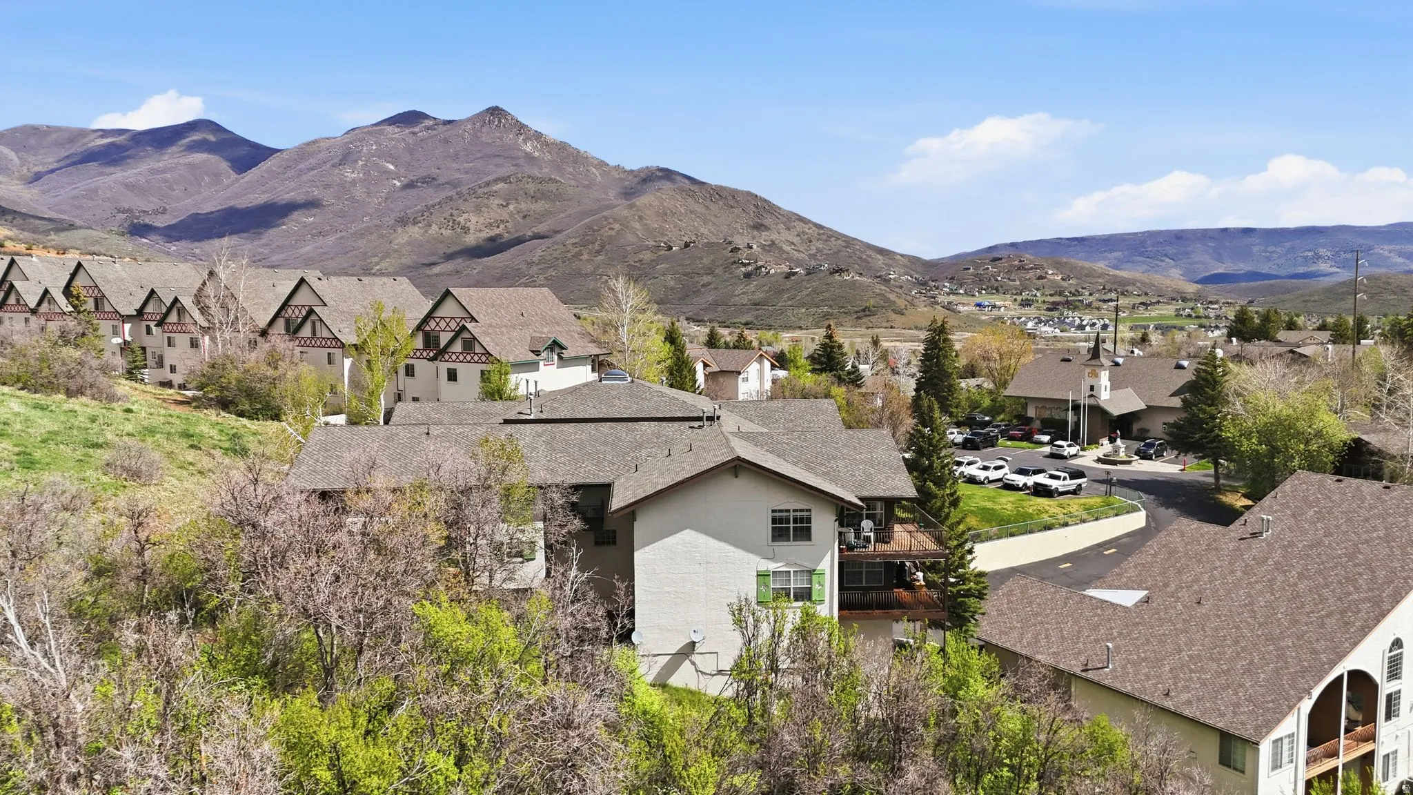 Architectural exteriors featuring pitched roofs and a mountainous backdrop
