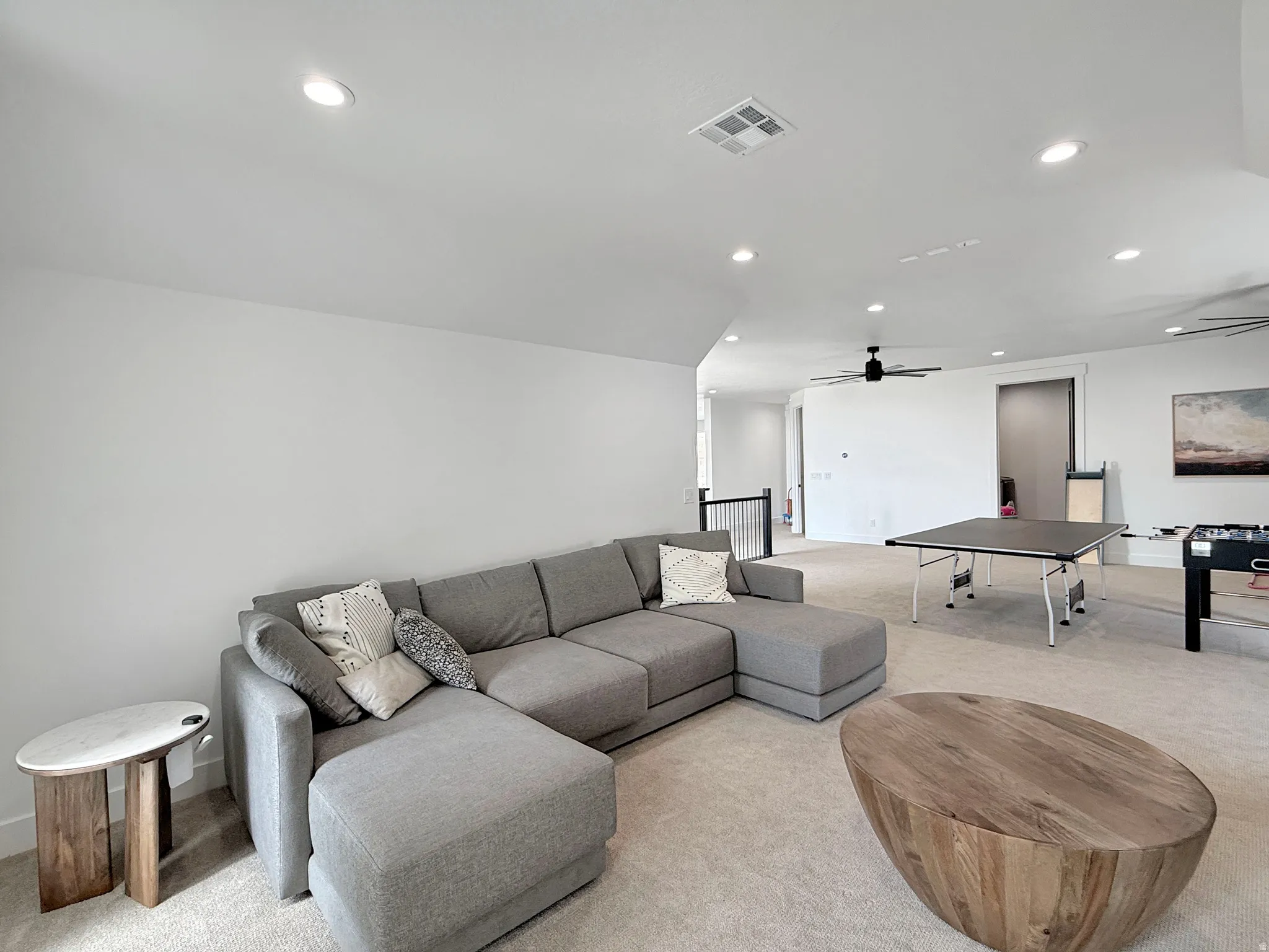 Open-concept room featuring recessed lighting, a ceiling fan, and light-toned carpet flooring