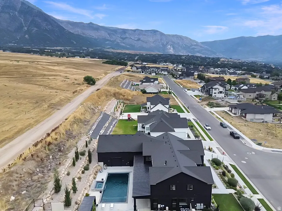 Mountain backdrop, contemporary exterior, private swimming pool, built-in hot tub, landscaped rock garden