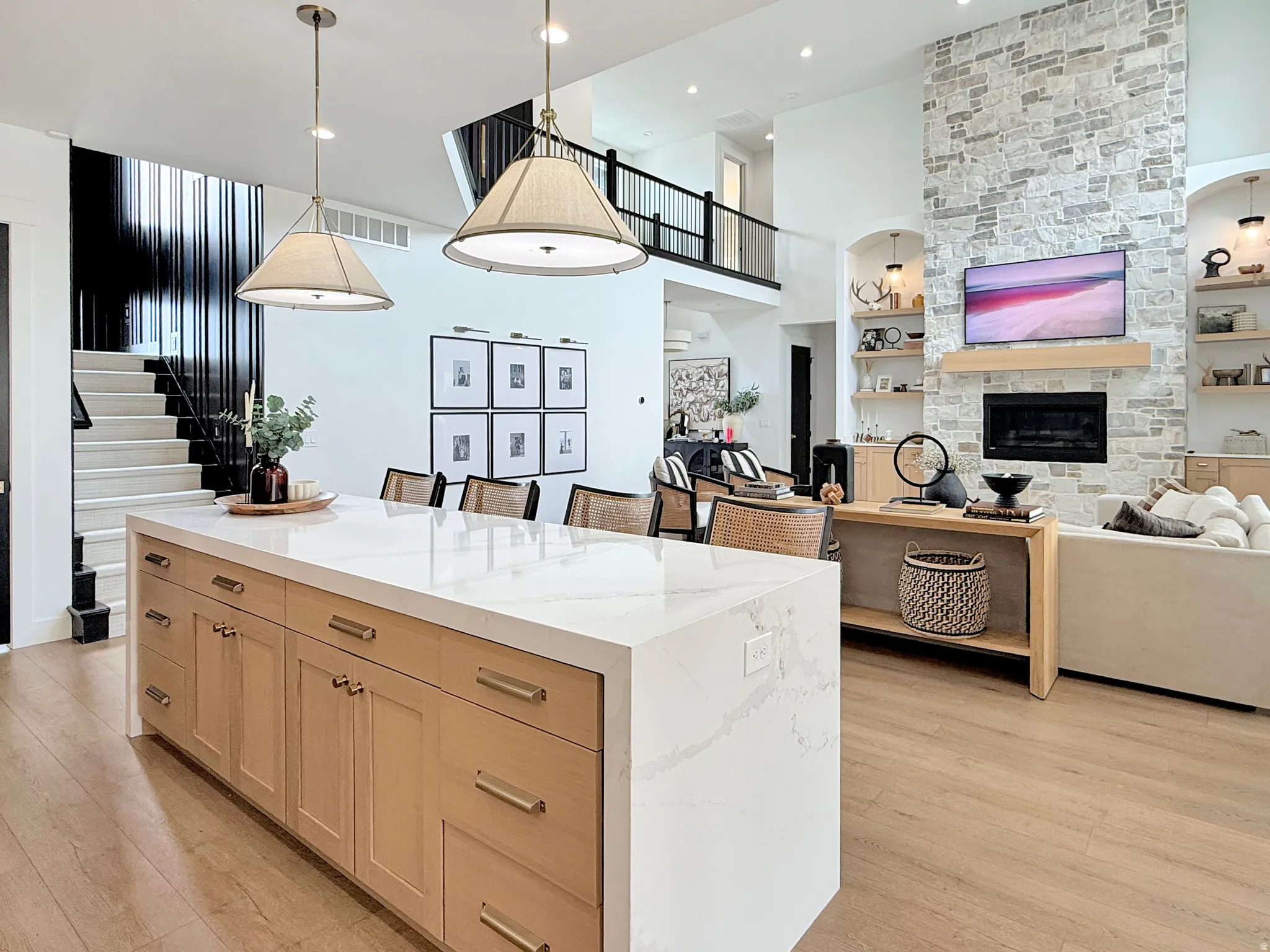 Kitchen island with light wood-finish cabinetry and a white countertop