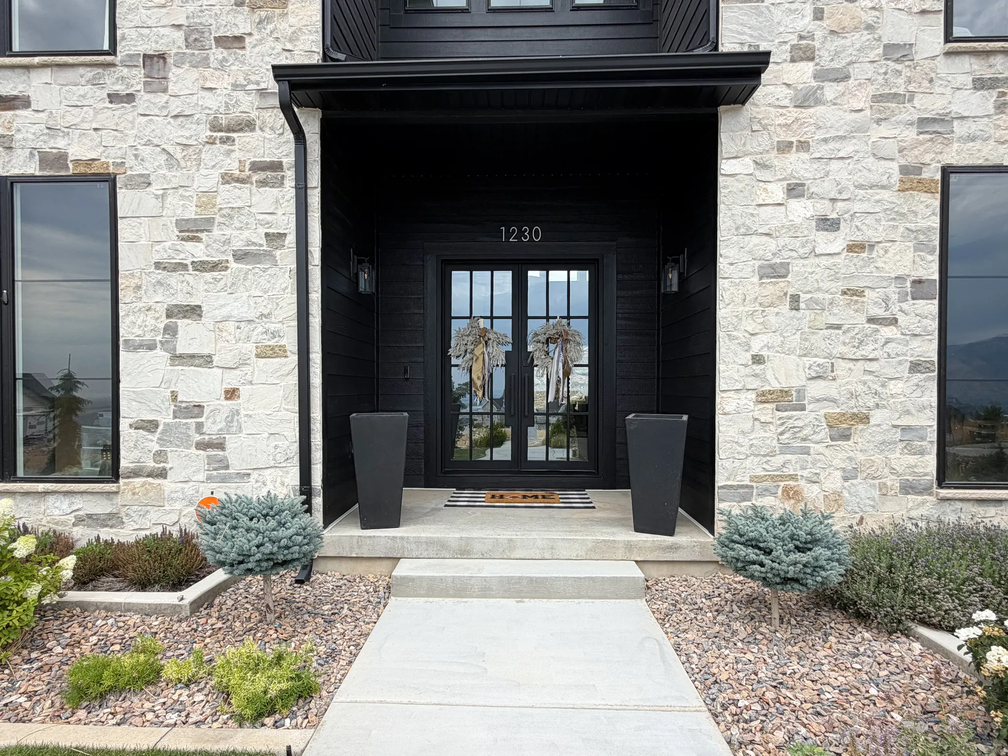 Stone veneer exterior with black trim windows
