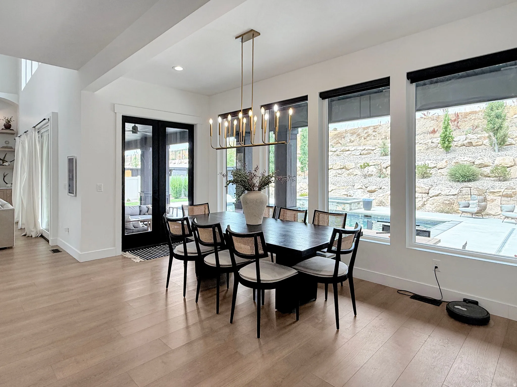 Spacious interior with light wood-finish flooring, high ceilings, and recessed lighting