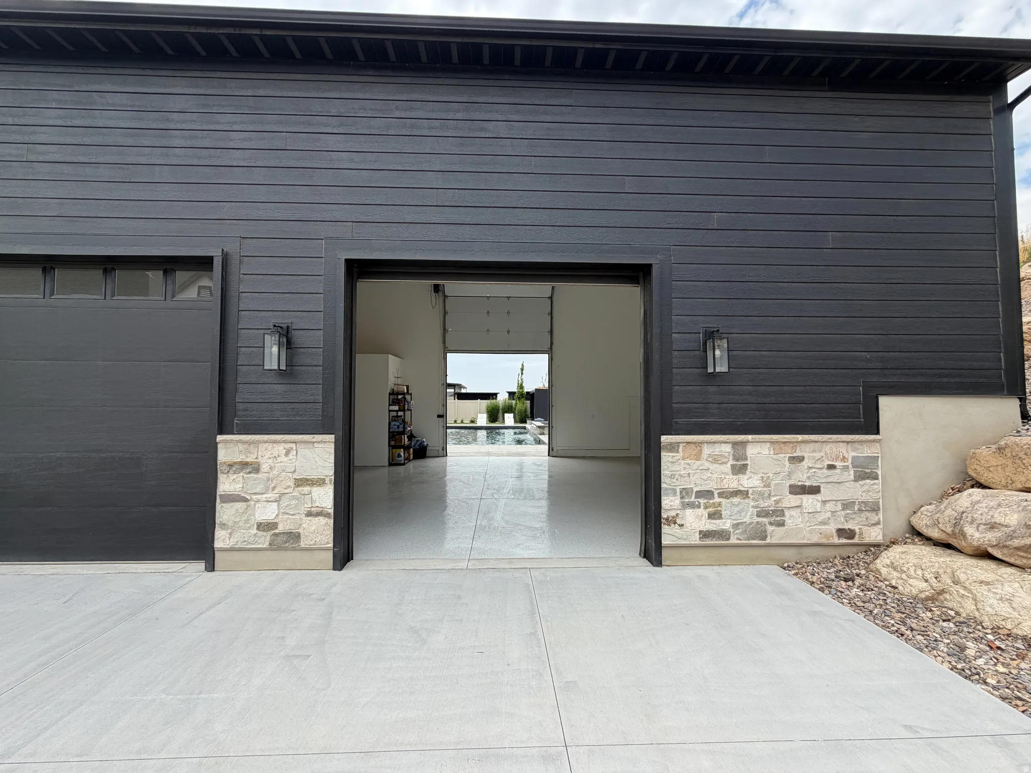 Black horizontal siding with stone veneer accents
