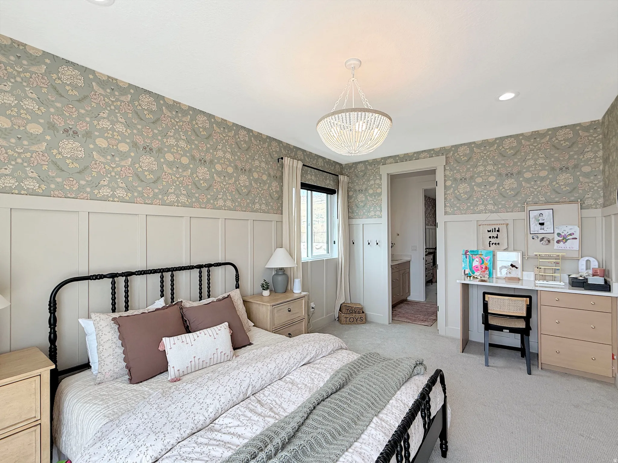 Patterned wallpaper, board and batten wall treatment, pendant light fixture, recessed lighting, and carpeted flooring