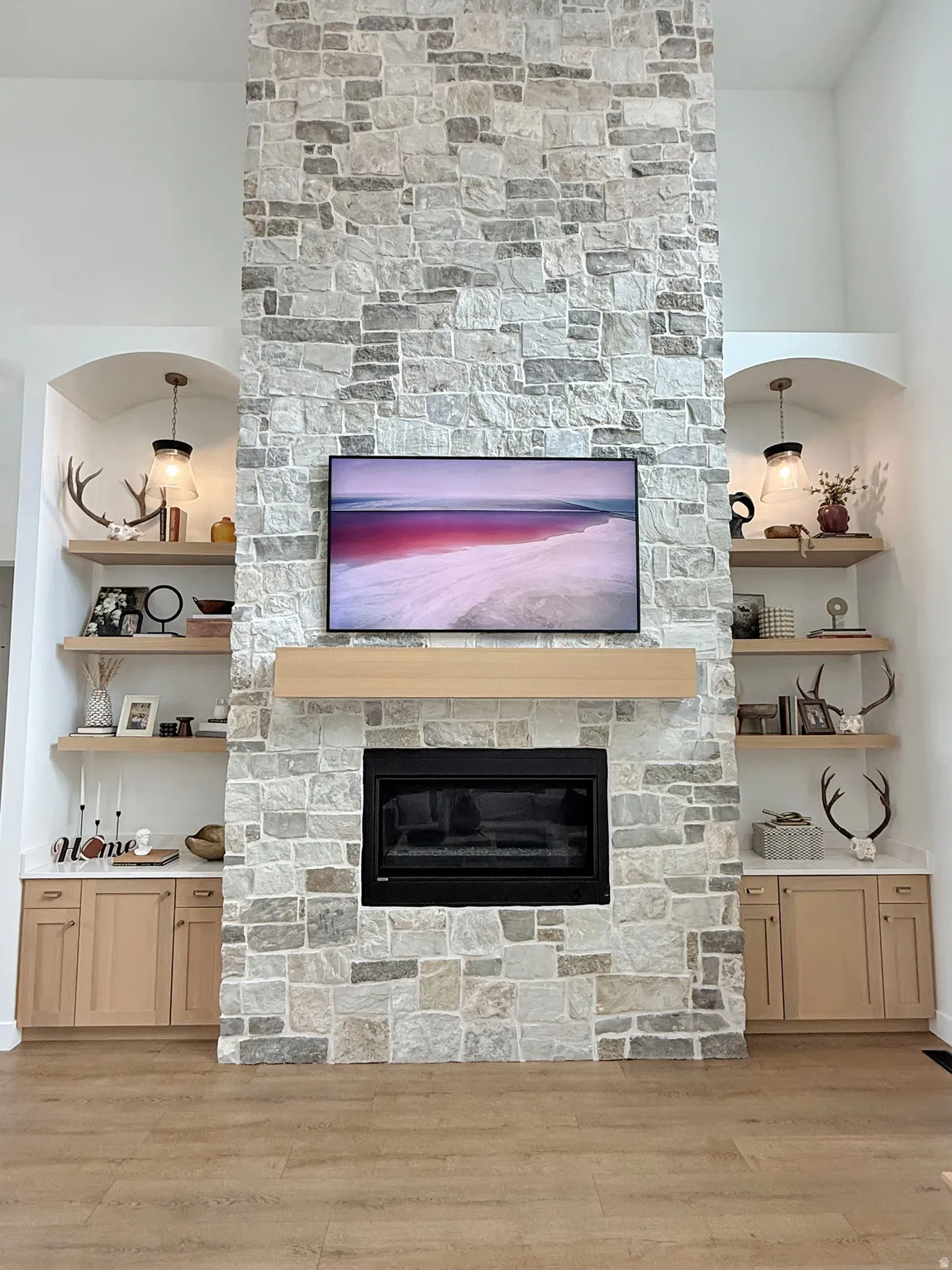 Stone-clad fireplace with a wood mantel and integrated firebox